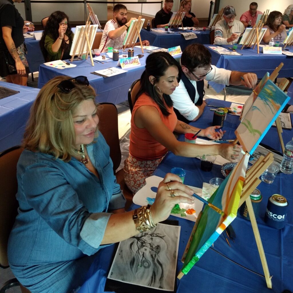 a classroom of adults participating in a painting class.